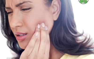 Woman touching her jaw in discomfort, showing signs of TMJ pain.