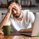 man drinking coffee exhausted