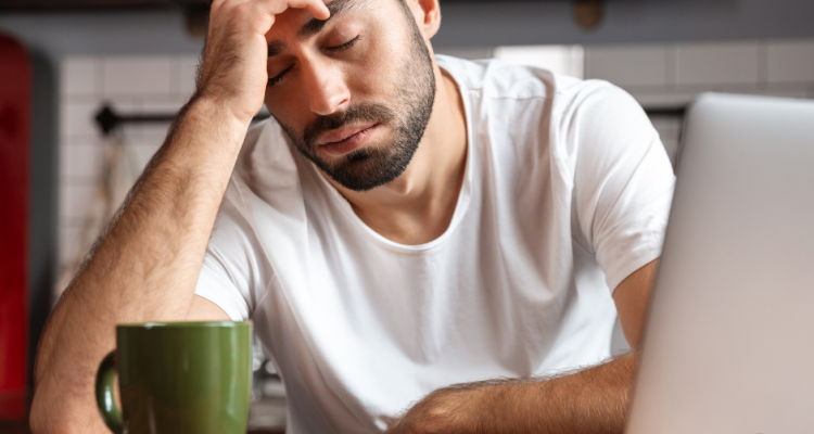 man drinking coffee exhausted